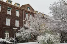 The exterior of the department of sociology in a winter setting with snow on the ground and on the trees